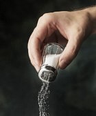 5777331-hand-adding-salt-using-a-salt-shaker